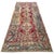 A richly patterned antique Turkish runner with the faded beauty and intricate detail of a well-loved textile. The deep red...