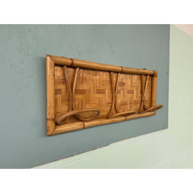 Vintage bamboo wall coat rack, a classic of 1960s Italian design. These furnishings feature a bamboo frame with a wicker...