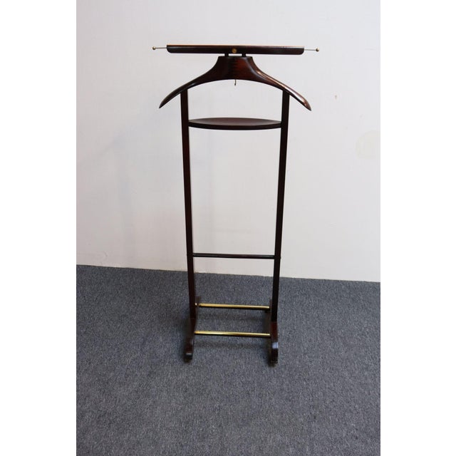 Handsome Italian valet/dressboy in richly stained mahogany designed by Fratelli Reguitti in the 1950s. This design is...