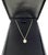 An exquisite Tiffany & Co. pendant necklace showcasing a vibrant round brilliant cut diamond weighing 0.44 carat with F...