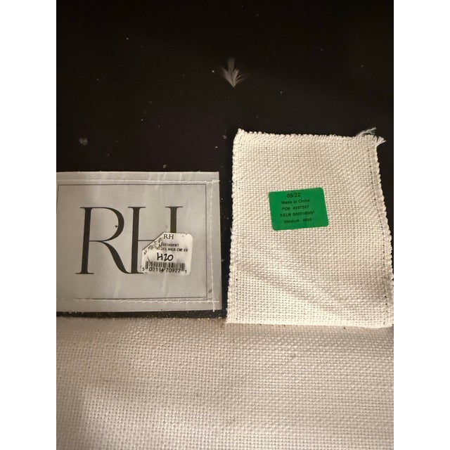 White Restoration Hardware couch made out of performance material which makes it easy to clean. We purchased it 2 years...