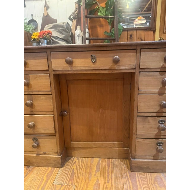 Early 20th Century Antique Pine knee-hole desk. Perfect for an office with 11 drawers and a central cabinet door that has...