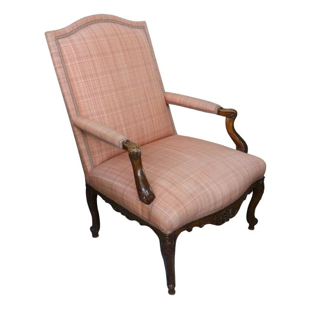 A fine French Regence Period carved walnut bergère, circa 1720. The shaped crest and upholstered back with carved exposed...