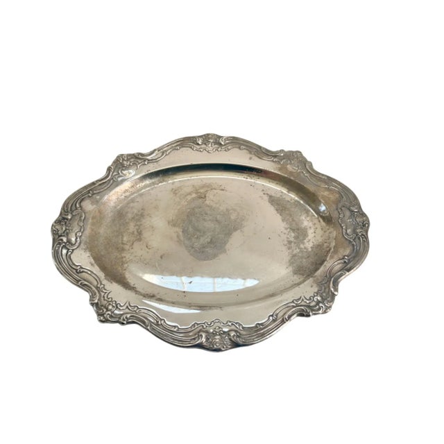 Vintage silver-plate serving tray with elaborate detailed rim. Perfect use for serving or use as a decorative piece.