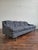 Classy mid-century modern sofa circa 1960s with an elegant silhouette, scalloped back and sloping arms. A lovely balance...