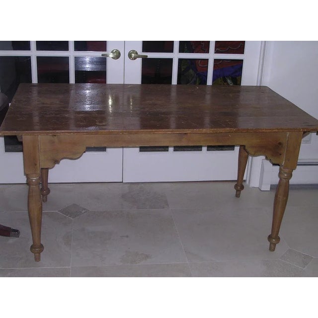 This beautiful antique farm table which is two pieces. The table top can be removed by the 2 dowels on each end of the...