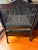 A commanding late 19th century cane armchair with an ebonized hardwood frame, caned back and side panels, scrolled open...
