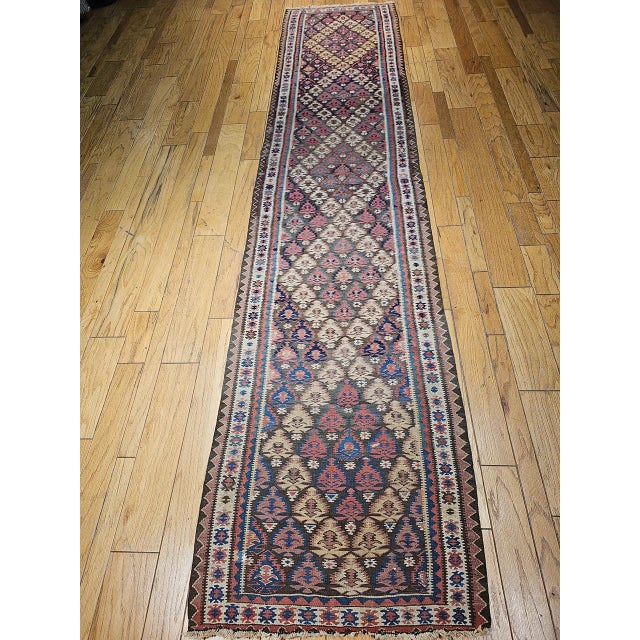 Vintage Persian Varamin kilim runner. Handwoven in the historic town of Varamin. This authentic flat-woven kilim showcases...