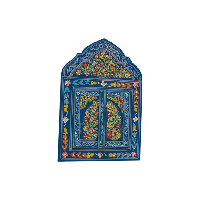 Bring a touch of Moroccan artistry into your home with this hand-painted wooden mirror. Featuring a vibrant floral motif...