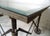 Custom built industrial accordion table features glass on top of a wood table top, accordion base that easily closes, on a...