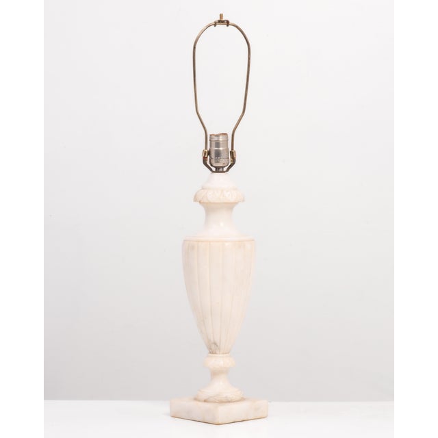A single alabaster urn shaped table lamp, made in Italy. Hand carved details, simple, elegant & beautiful. The base is...