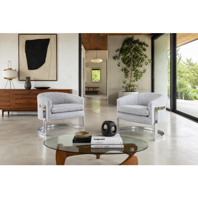 An exceptional pair of mid-century modern chrome “Barrel” lounge chairs attributed to celebrated American designer Milo...