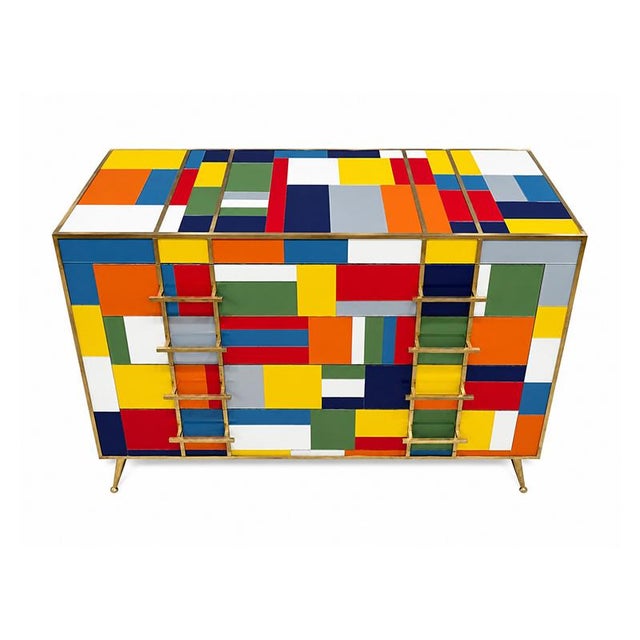 This 4-drawer dresser, entirely handmade, features a wooden frame covered in multicolored glass; gilded brass trim and...