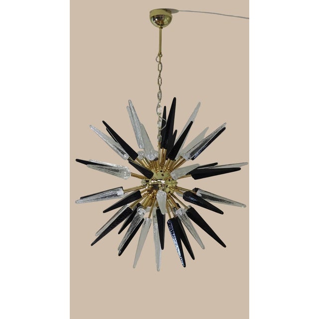DUTIES FREE Italian Sputnik chandelier with 51 hand-blown Murano glass tips in clear and black, brass frame. Late-XX-...