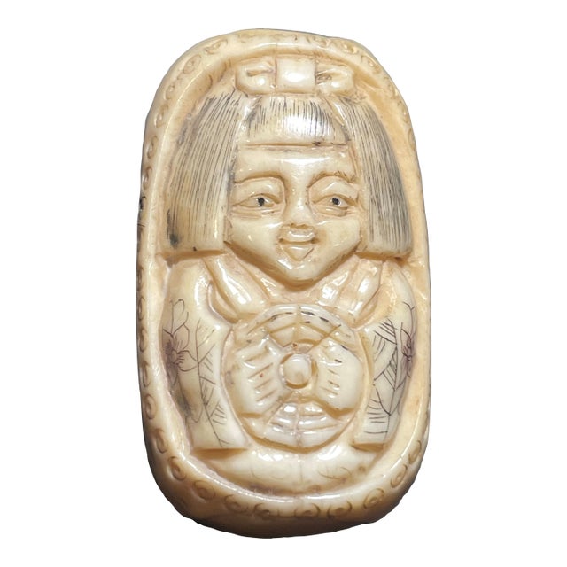 Antique Carved Ojime Bead Depicting a Smiling Figure Holding a Coin. 19th Century Japanese Edo Style. For Sale