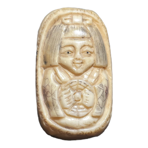 Antique Carved Ojime Bead Depicting a Smiling Figure Holding a Coin. 19th Century Japanese Edo Style.