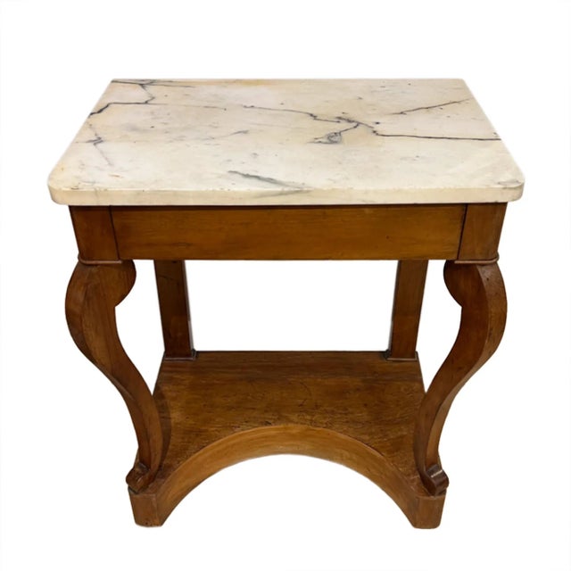 This is a lovely small antique console or side table, made in France in the mid-19th century, with a refined yet...