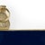 Navy enamel wall frame trimmed in textured gold, holds 4 x 4 photo. 11.5h x 8.5w x .8d
