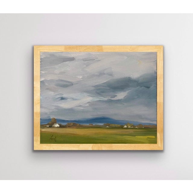 Rain To The North captures a serene landscape under a dramatic sky, where swirling clouds hint at an impending storm. The...