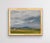Rain To The North captures a serene landscape under a dramatic sky, where swirling clouds hint at an impending storm. The...