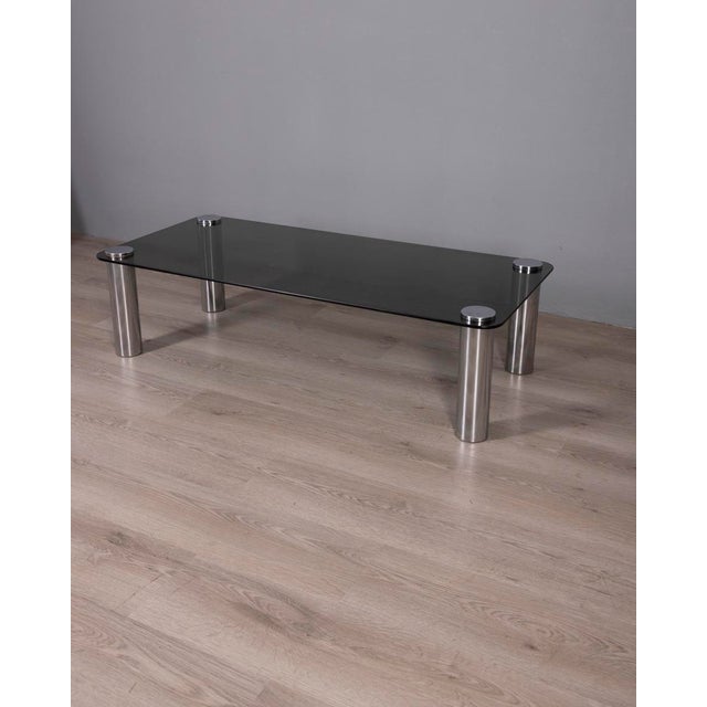 Coffee table with cylindrical chromed metal legs and a smoked glass top, designed by Marco Zanuso for Zanotta, 1970s. I...