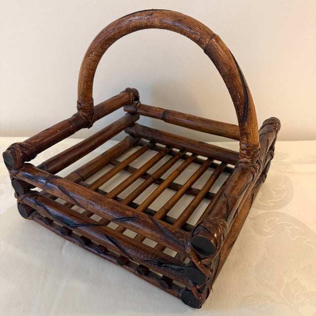 Vintage bamboo and wicker handled serving basket with a warm brown finish and decorative wrapped construction. A versatile...