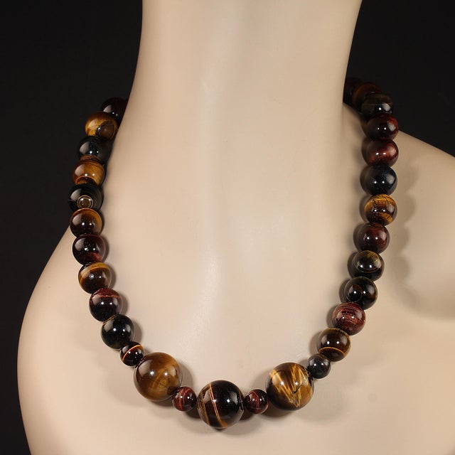 Elevate your accessory game with this stunning 25-inch multi-color Tiger's Eye necklace, designed to capture the warm,...