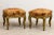 Pair antique footstools or benches on casters with floral upholstery. Good condition overall with slight finish loss due...
