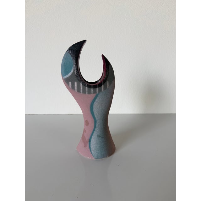 A striking 1992 vintage hand-crafted ceramic sculptural vase featuring an elegant open-form silhouette with a bold...