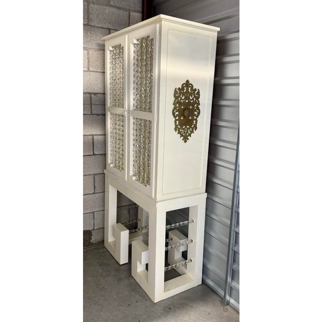 Make a bold statement with this extraordinary vintage cabinet that perfectly captures the glamour of Hollywood Regency and...