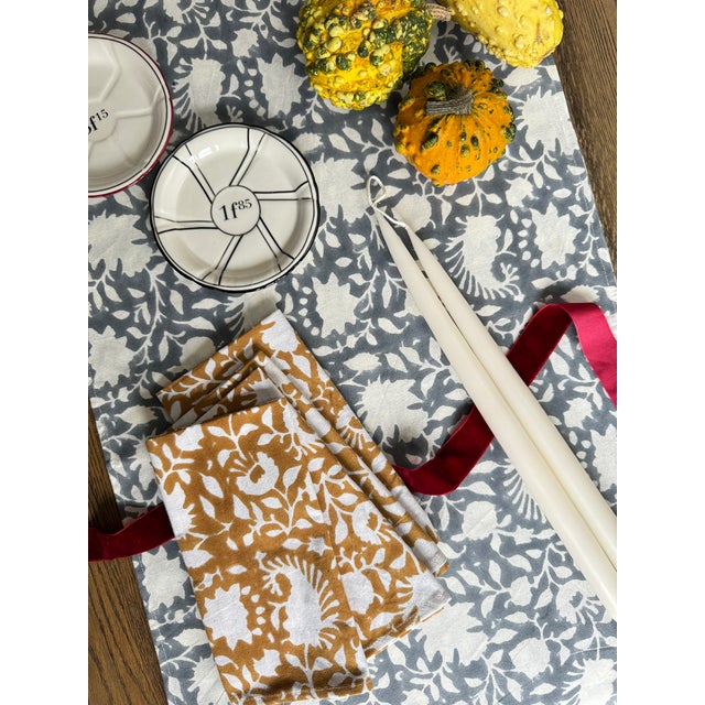 Hand block printed table runner featuring a classic floral design in grey against white cotton. 17" x 108" Made in India...