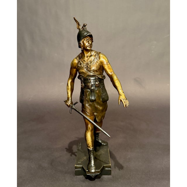 This finely cast French bronze sculpture by Émile Picault (1833–1915) depicts a classical warrior captured in purposeful...