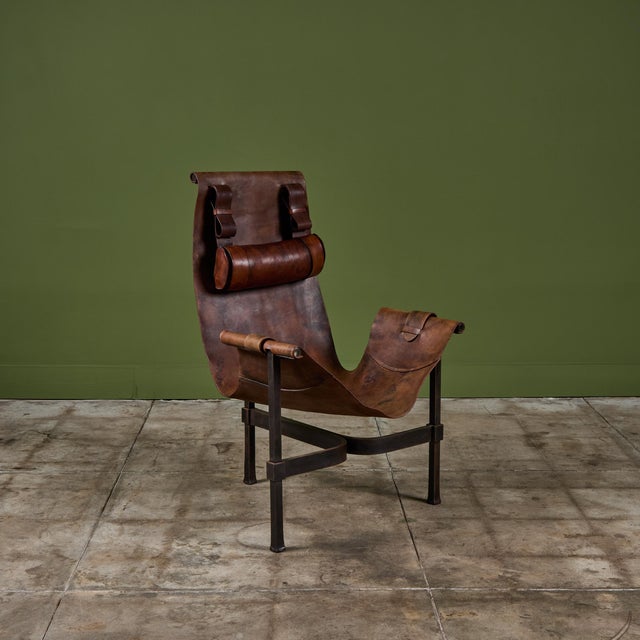 Patinated leather sling chair by Jean-Paul Rykaert c.1970's, France. The chair features a heavy steel T-frame and dark...