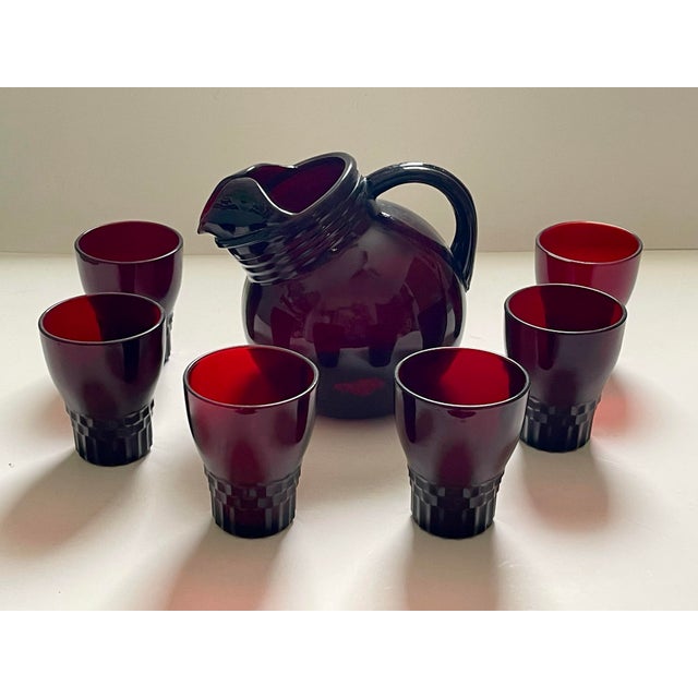 A vintage ruby glass juice set in an art deco style. The pitcher was specially designed at an angle to fit in the fridges...