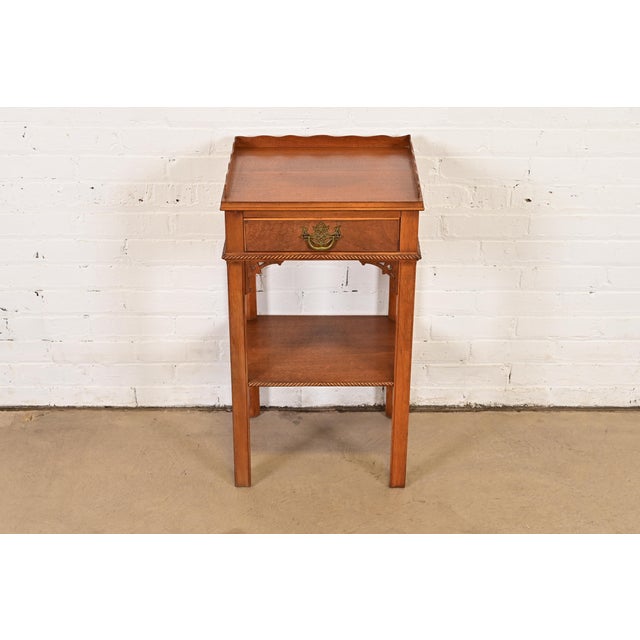 A gorgeous Georgian or Chippendale style nightstand or occasional side table In the manner of Baker Furniture By Northern...