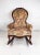 A vintage Kimball and Victorian era in style parlor rocking chair with fabulous floral velvet tufted upholstery and a...