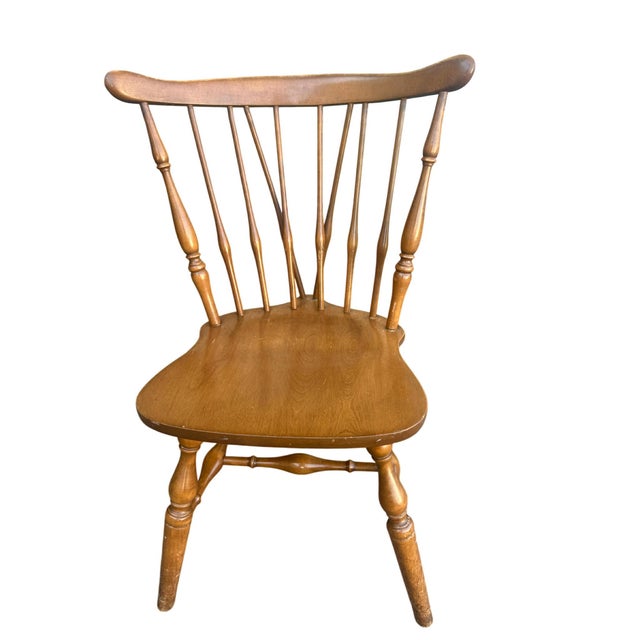 A set of four Mid 20th Century Windsor style dining chairs. Solid maple, nutmeg finish, fiddleback with turned side...