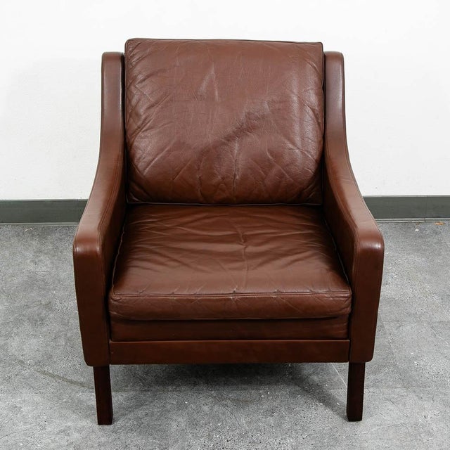 Danish Modern lounge chair in brown leather. Imported directly from Denmark in our most recent shipment. A classic style...