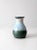 This is a vintage studio pottery vase. Signed by the artist, the handmade ceramic vase has a beautiful blue and green glaze.