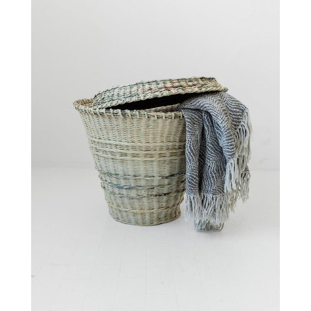 This vintage large laundry basket from the 1990s is a unique handcrafted piece made from woven newspaper, showcasing an...
