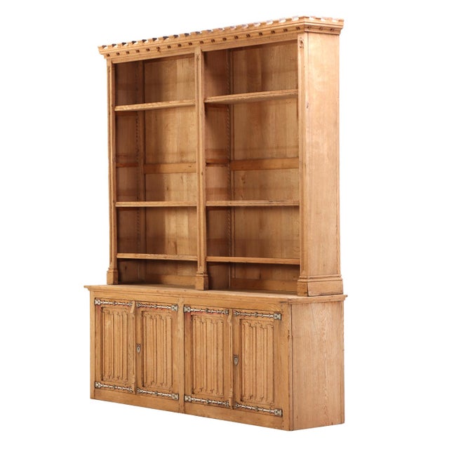 Handsome and architectural, this oak cabinet features an open upper section over a closed lower base. The design is...