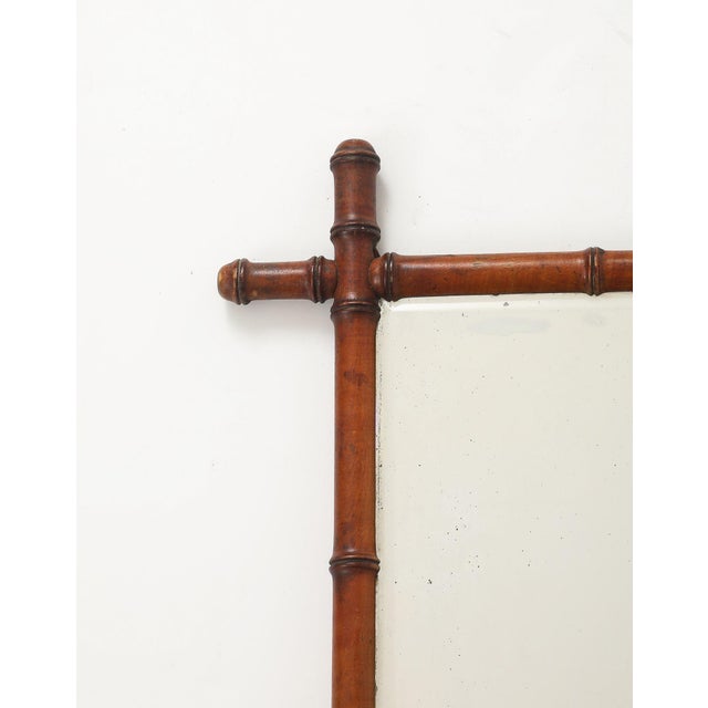 This charming 1940s English mirror features a finely carved faux bamboo frame with a rich, warm patina that beautifully...