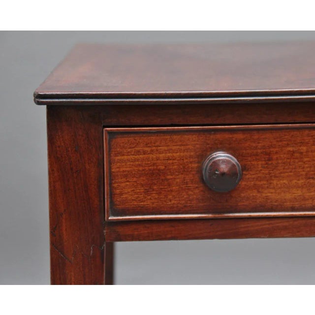 - Mahogany writing or side table from circa 1800 - On square tapered legs and castors - A drawer on one end and a faux...