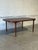 This elegant dining table features a minimalist rectangular profile. The streamlined silhouette showcases classic...