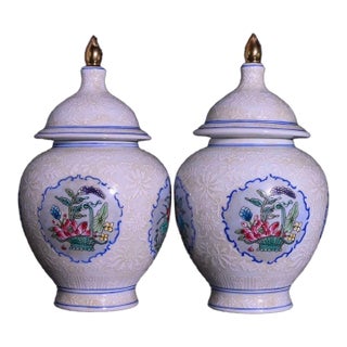 Pair of Chinese White Glazed Porcelain Jars With Floral Panels & Gilt Finials For Sale