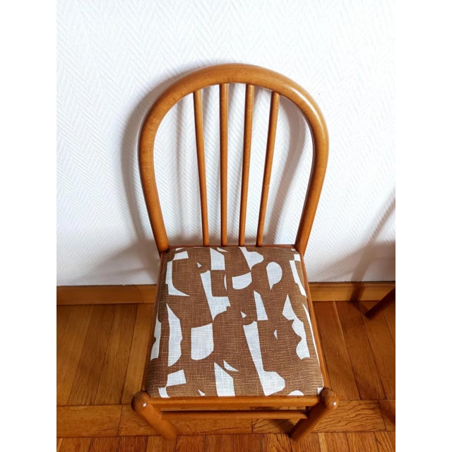 Set of three vintage chairs, pine-style wooden frames with rounded legs and a slatted backrest. The seat has been...