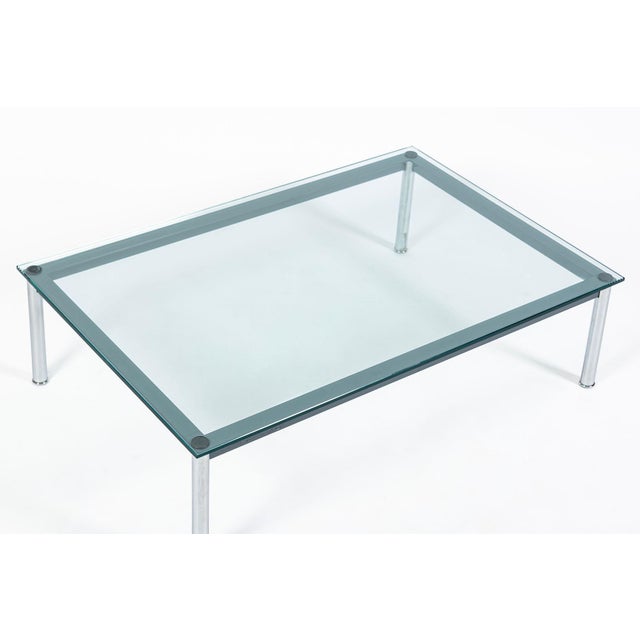 This classic Bauhaus LC10-P steel and glass low coffee or cocktail table was designed by Le Corbusier, Charlotte Perriand...