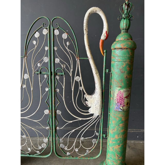 Pair of whimsical garden gates. These are lovely, decorative gates with swans. Rare find! Recently sold at auction for 7k.