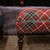 Meticulously handcrafted in the United Kingdom, this upholstered stool boasts classic studding and hand-polished solid...