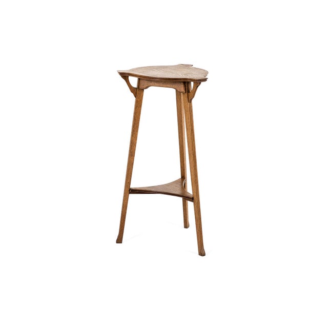 A rare vienna secession oak jardinière stand on slender tripod supports. The shapely top bears a moulded edge with a...